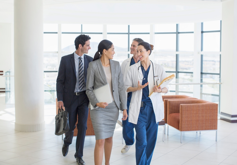 Doctors And Business People talking in a hospital lobby