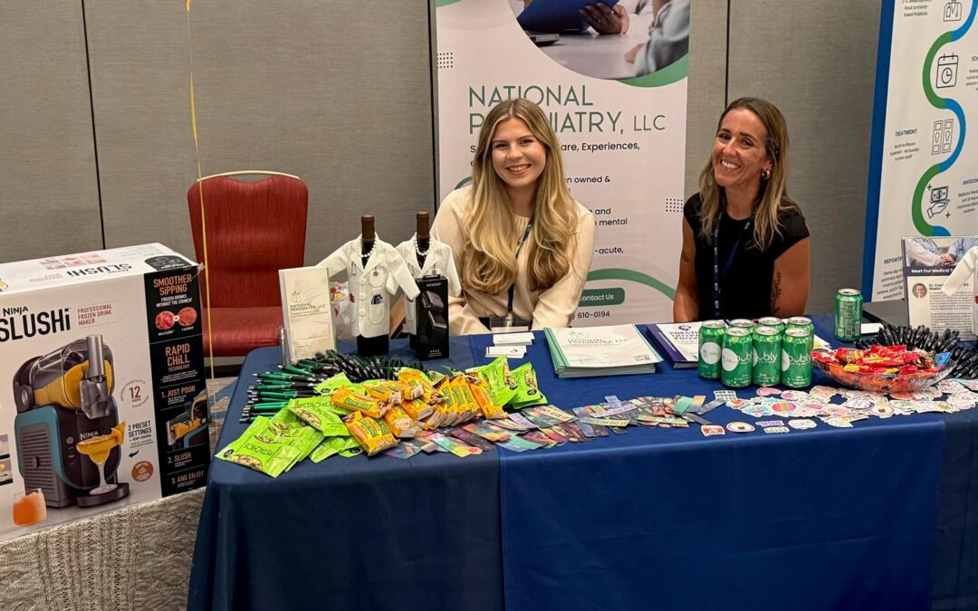 Two women are seated at a table, surrounded by an array of items, discussing and exploring the contents together